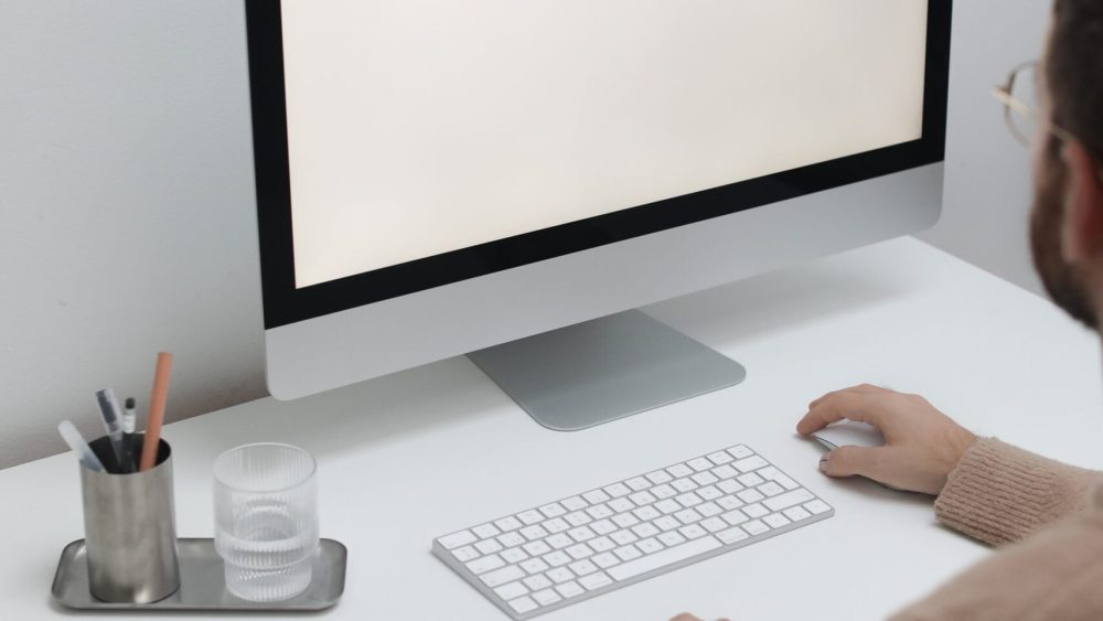Free Crop man working on computer in workplace Stock Photo