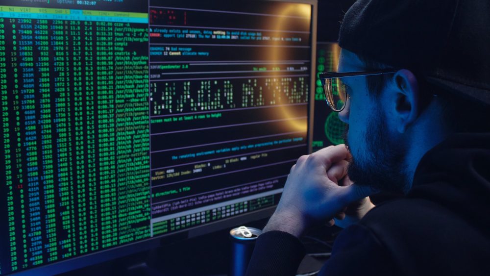 Free A Man Looking at a Computer Screen with Data Stock Photo