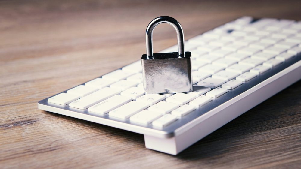 a computer keyboard with a padlock on top of it