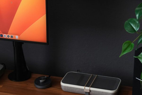 a desk with a laptop, keyboard, mouse and a monitor