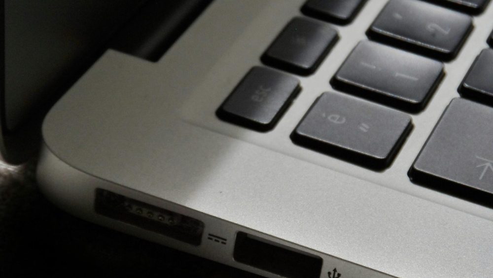 Free Detailed view of a silver laptop showing keyboard and multiple ports. Stock Photo
