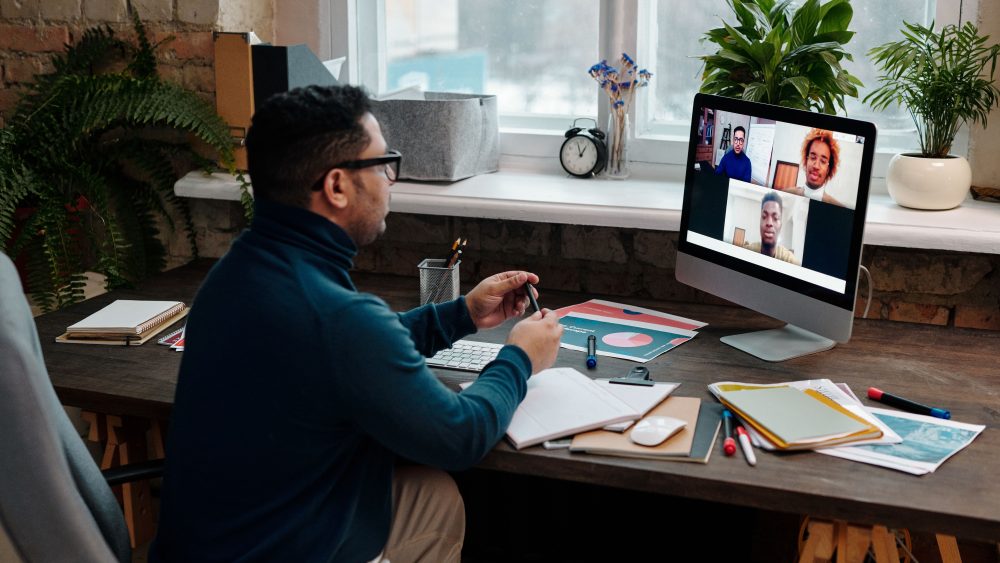 teacher-video-calling-with-his-students-using-a-computer
